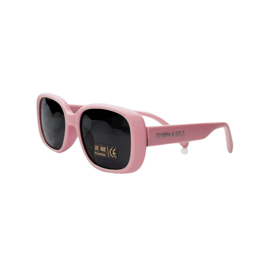 Angle view of kids UV polarised coral pink sunglasses showing flexible frames