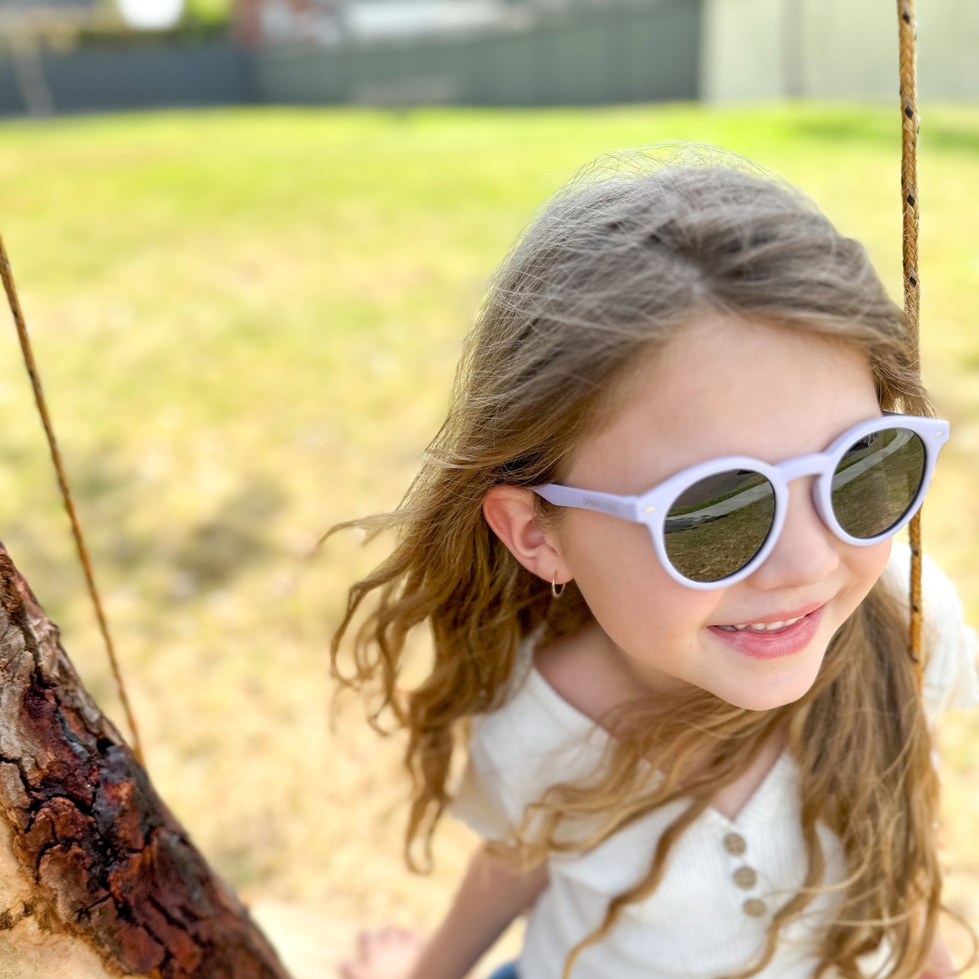 girl wearing purple UV polarised kids flexible sunglasses