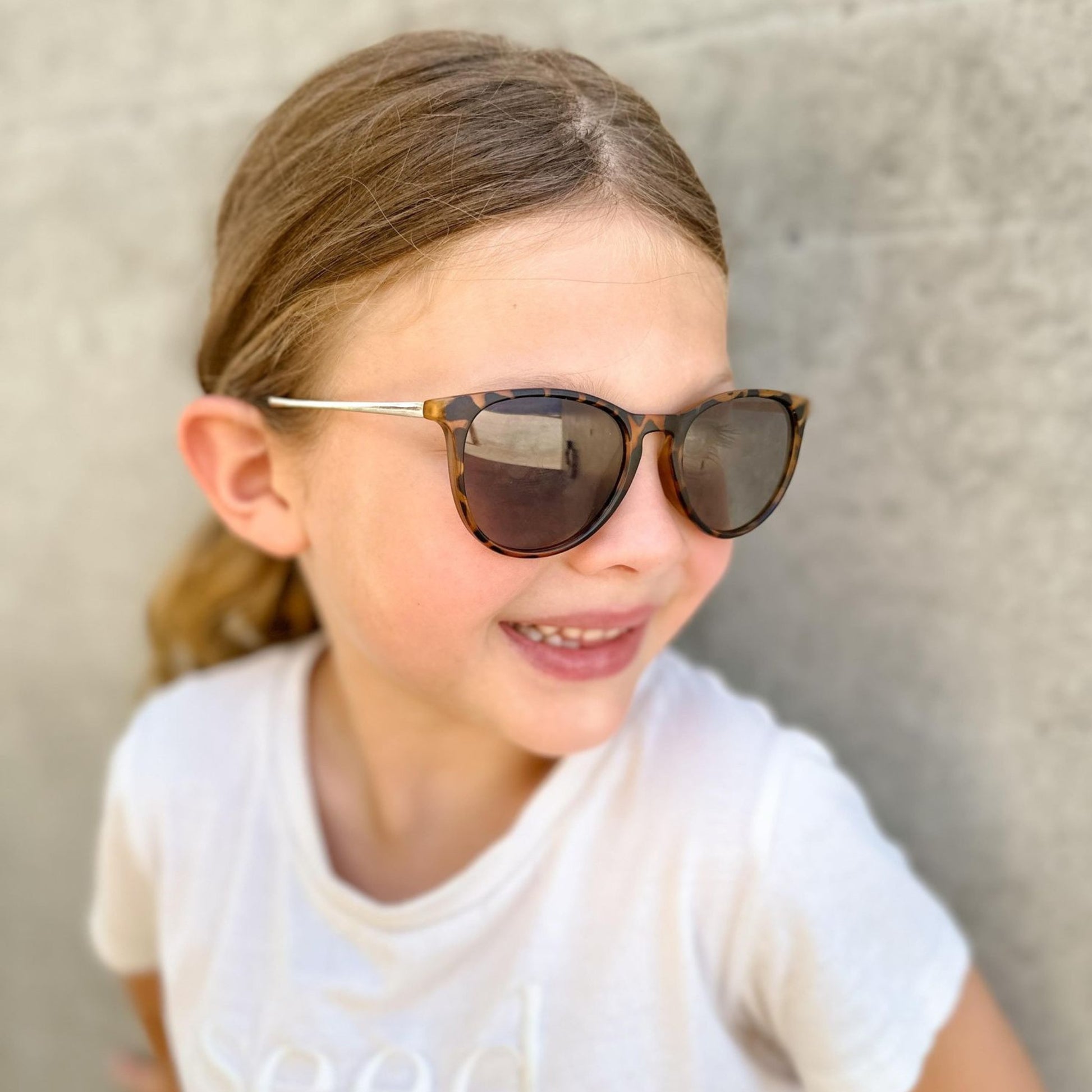 girl wearing polarised UV tortoise shell sunglasses