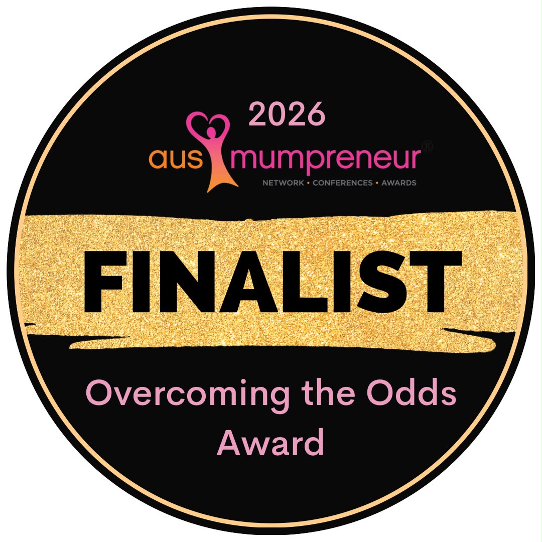 A circular black and gold badge for the 2026 Aus Mumpreneur award, featuring a glittery gold horizontal band with the word 'FINALIST' in bold black letters, and pink and orange text reading 'Overcoming the Odds Award'.